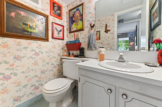 bathroom with vanity, toilet, and tile patterned flooring