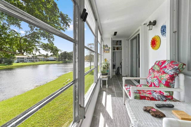 sunroom / solarium with a water view and plenty of natural light