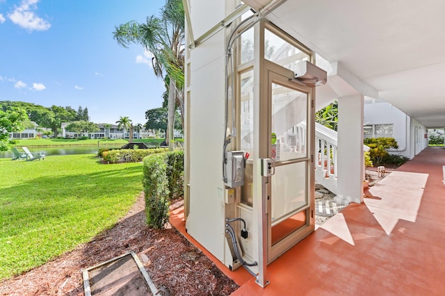 view of outdoor structure with a water view and a yard