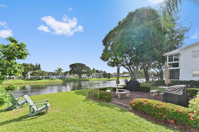 view of yard featuring a water view and a patio area