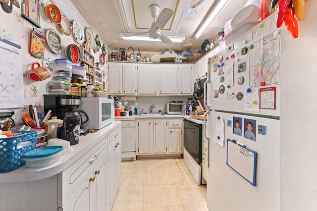 kitchen featuring white appliances, ceiling fan, white cabinetry, and sink