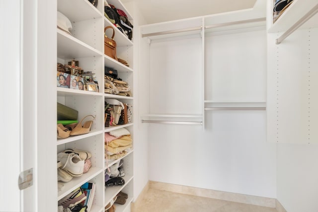 spacious closet with light tile patterned floors