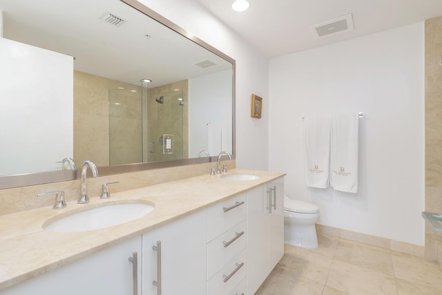 bathroom featuring tile patterned floors, vanity, toilet, and walk in shower