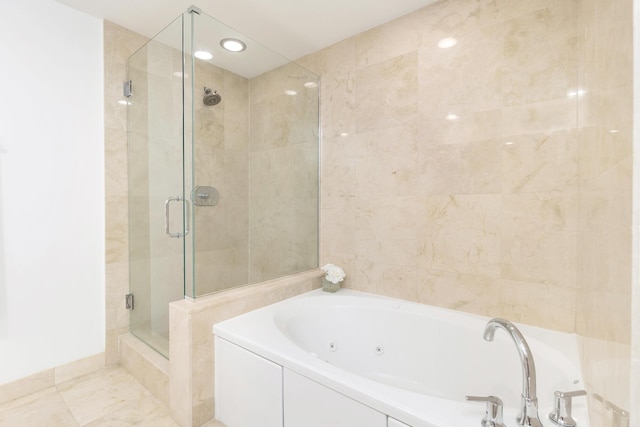 bathroom featuring a stall shower and a jetted tub