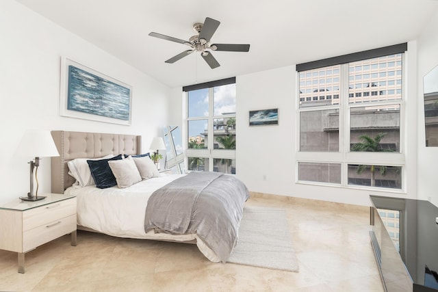 bedroom with a wall of windows and a ceiling fan