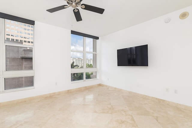 unfurnished living room featuring ceiling fan