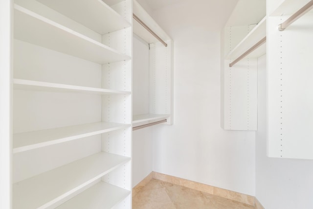 spacious closet featuring light tile patterned floors