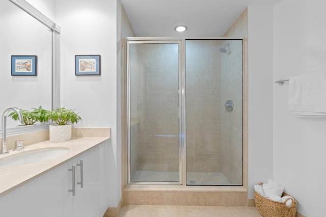 bathroom with tile patterned floors, vanity, and an enclosed shower