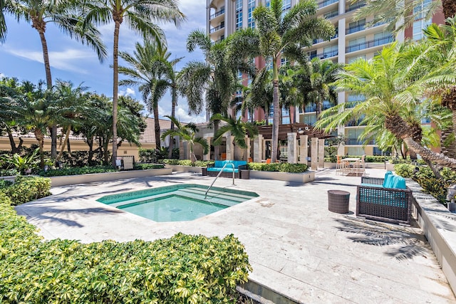 view of swimming pool with a patio and a community hot tub