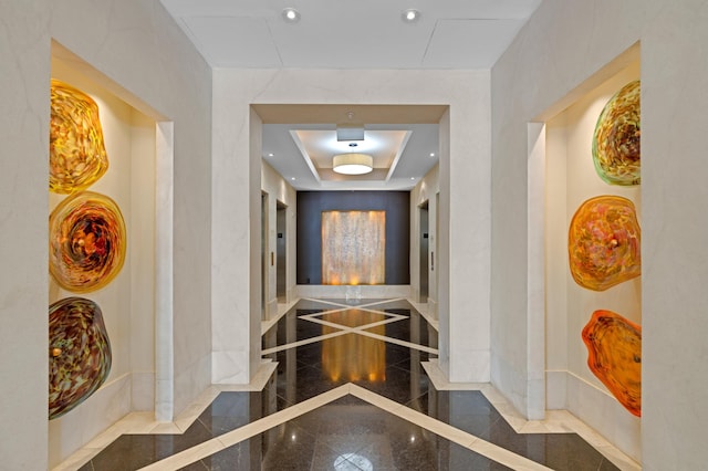 hall featuring recessed lighting, granite finish floor, and baseboards