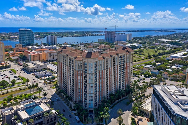 birds eye view of property with a water view and a view of city