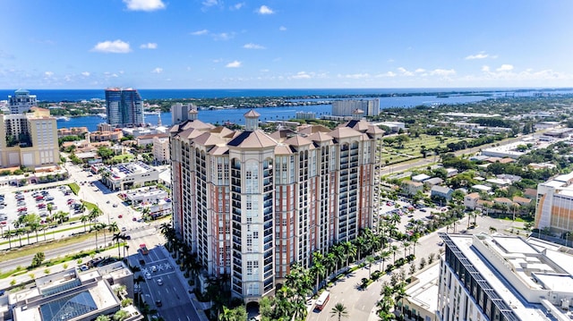 birds eye view of property with a water view and a city view