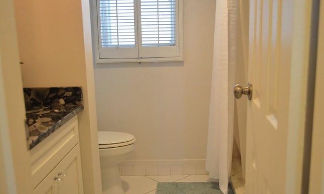 bathroom with toilet, vanity, tile patterned floors, and a shower with shower curtain