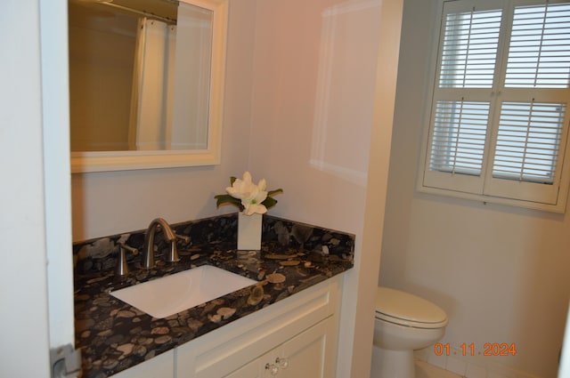 bathroom featuring vanity and toilet