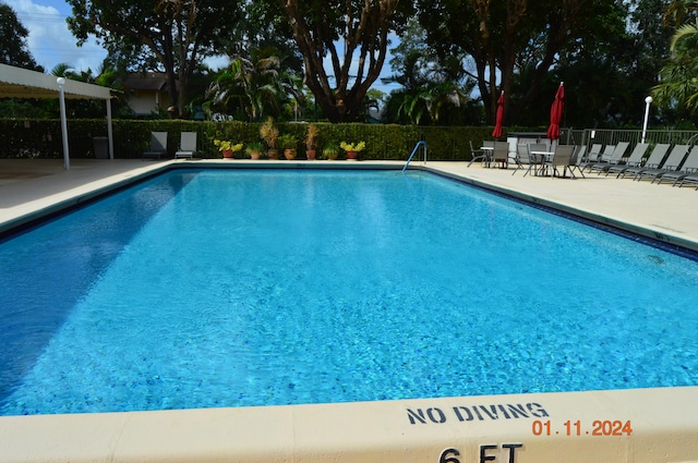 view of swimming pool featuring a patio area