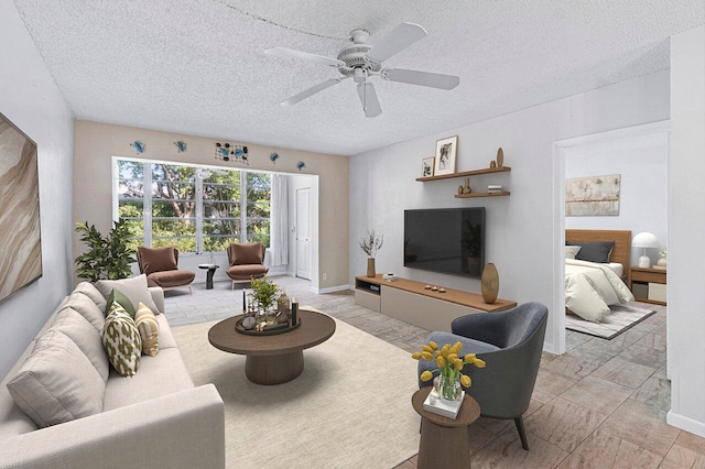 living room with a textured ceiling and ceiling fan