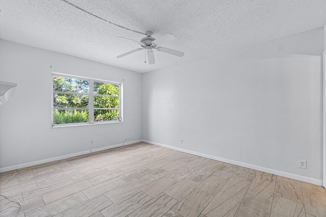 empty room featuring a textured ceiling and ceiling fan