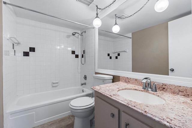 full bathroom featuring vanity, tiled shower / bath combo, toilet, and tile patterned flooring