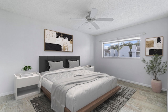 bedroom with a textured ceiling and ceiling fan