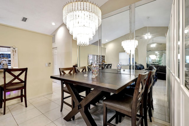 tiled dining room featuring ceiling fan with notable chandelier and lofted ceiling