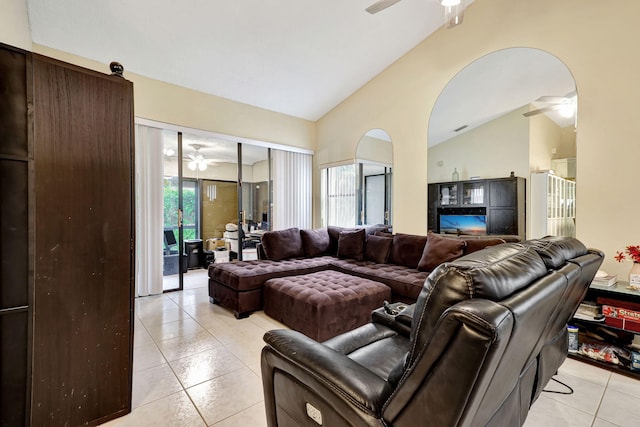 living room with lofted ceiling and light tile patterned flooring