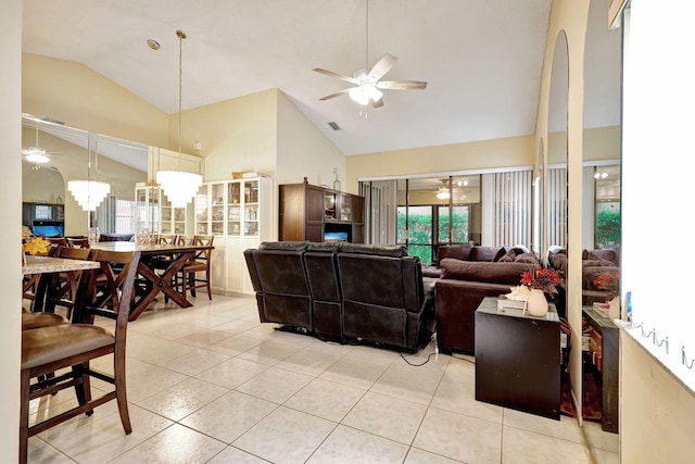 living room with light tile patterned flooring, high vaulted ceiling, and an inviting chandelier