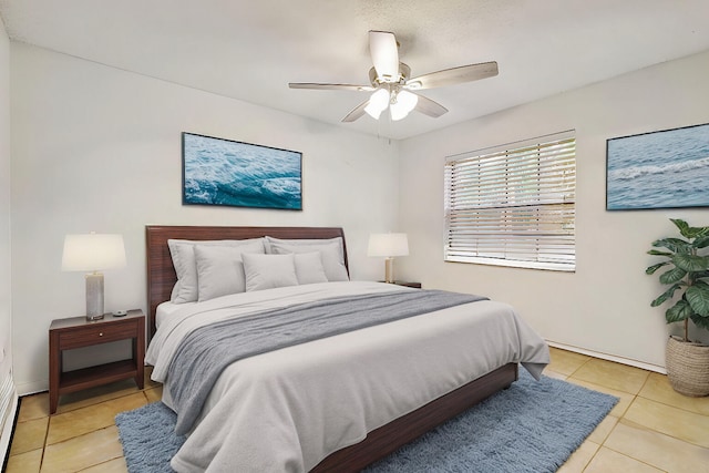 bedroom with ceiling fan and light tile patterned floors