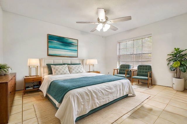 tiled bedroom featuring ceiling fan