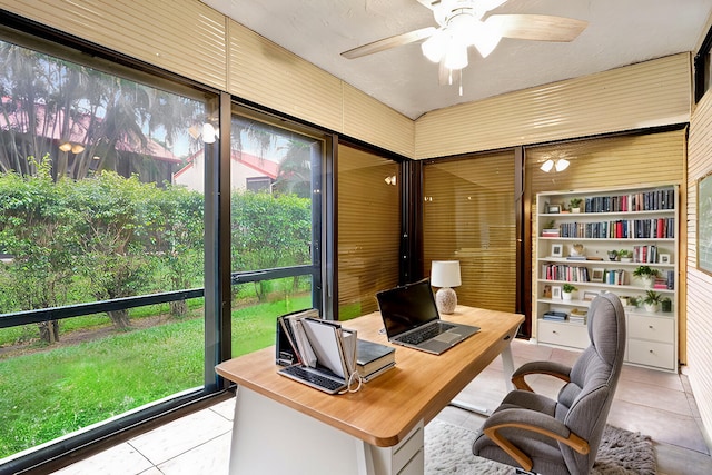 tiled home office with built in shelves and ceiling fan