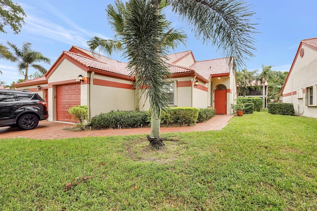 view of front facade featuring a garage and a front yard