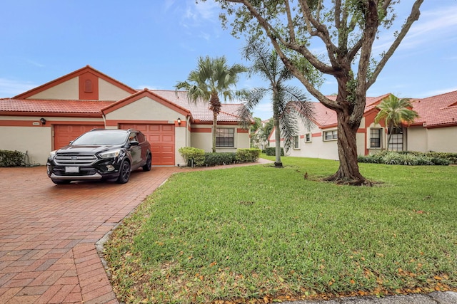 view of front facade with a garage and a front lawn