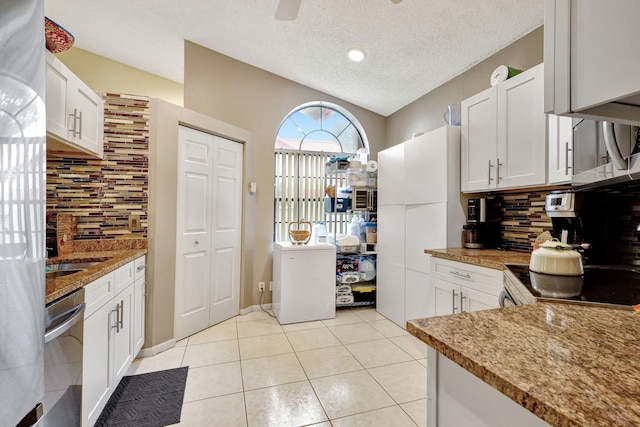 kitchen featuring white cabinets, a textured ceiling, appliances with stainless steel finishes, and tasteful backsplash