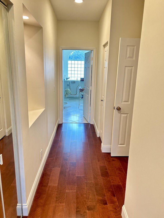 corridor featuring dark wood-type flooring