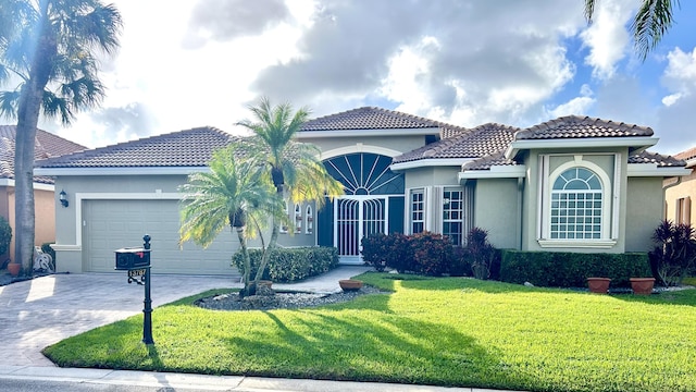 mediterranean / spanish-style home featuring a garage and a front lawn