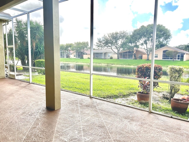 unfurnished sunroom with a water view