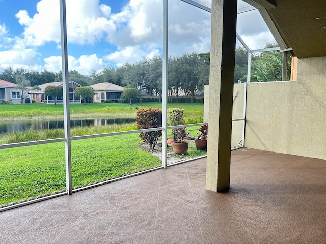 unfurnished sunroom with a water view