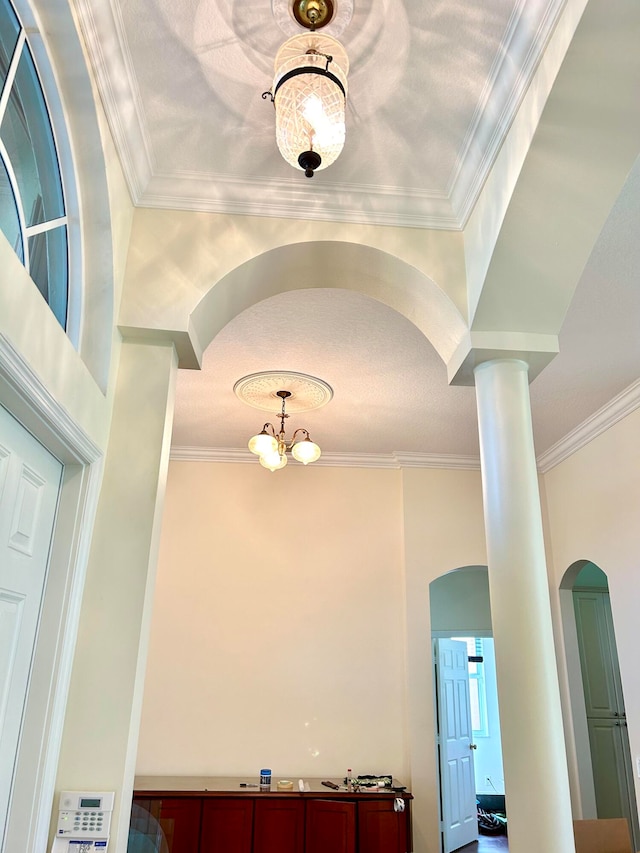 room details with ornamental molding and a notable chandelier