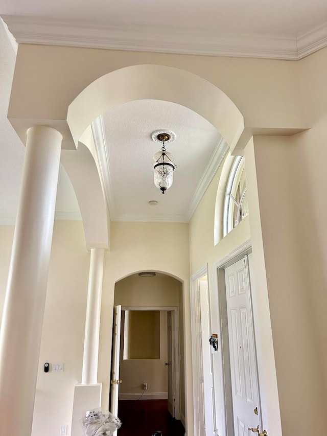 corridor featuring a textured ceiling and ornamental molding