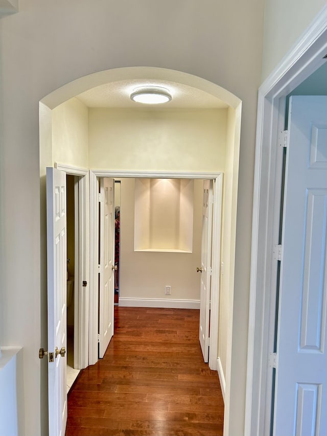 corridor featuring dark hardwood / wood-style floors