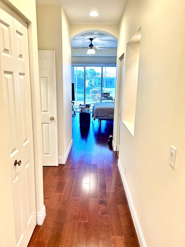 hallway with dark hardwood / wood-style flooring