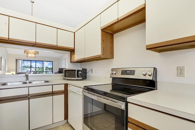 kitchen featuring sink, light tile patterned floors, an inviting chandelier, stainless steel appliances, and white cabinets