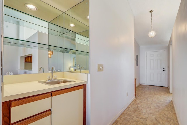 bar with light tile patterned flooring, sink, and hanging light fixtures