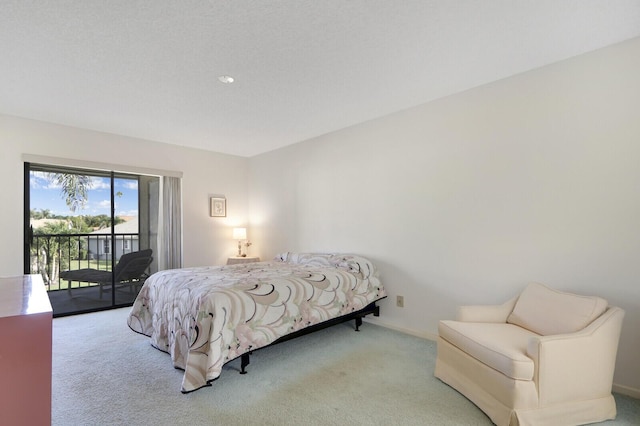 bedroom featuring access to exterior and light carpet