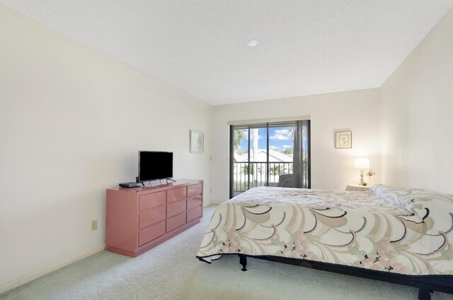 bedroom featuring light colored carpet and access to exterior