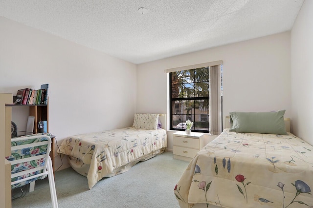 carpeted bedroom featuring a textured ceiling