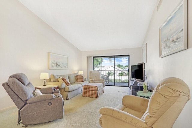 carpeted living room with high vaulted ceiling