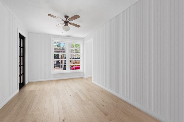 spare room with light hardwood / wood-style floors and ceiling fan