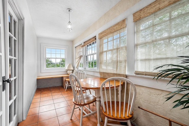 dining area featuring tile patterned flooring and a textured ceiling