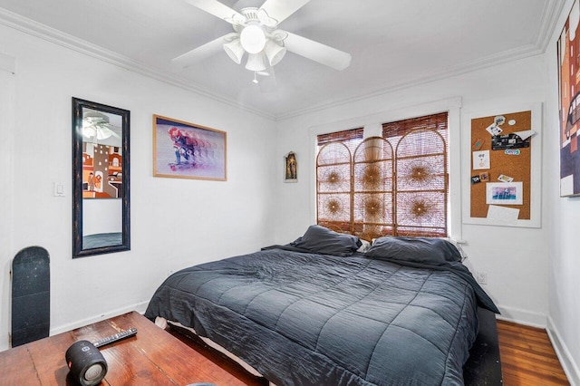 bedroom featuring hardwood / wood-style flooring, ceiling fan, and crown molding