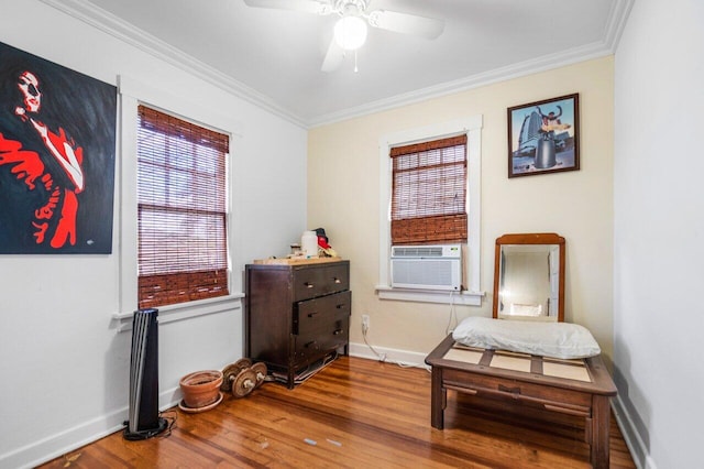 living area featuring hardwood / wood-style flooring, ceiling fan, cooling unit, and crown molding